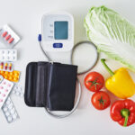 Digital,Blood,Pressure,Monitor,,Fresh,Vegetables,And,Medical,Pills,On