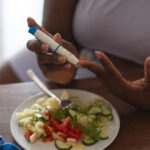 high-angle-woman-checking-glucose-levels